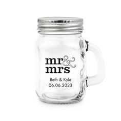 a glass mug with the words mr and mrs on it, sitting in front of a white background