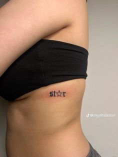 a woman's stomach with the word sit tattooed on her lower back and side