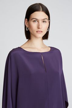 DETAILS Crafted in our signature crepe de chine fabrics, the Wendy top features a silky-smooth texture and flowy drape. It features a rich, deep palette that’s perfect for the season. Framed by an alluring neckline, this style’s fluid silhouette transitions with caftan sleeves. Crew neck Cape sleeve Hip length Non stre Evening Long Sleeve Silk Crepe Top, Elegant Draped Tops, Sleek Viscose Evening Tops, Sleek Viscose Tops For Evening, Drapey Evening Blouse, Elegant Silk Crepe Top For Evening, Elegant Flowy Evening Tops, Formal Silk Blouse With Draped Sleeves, Chic Evening Drapey Blouse