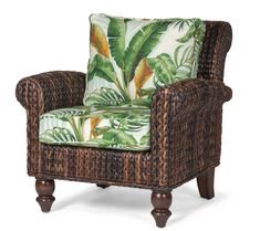 a wicker chair with tropical print upholstered seat