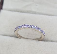 This Ring comes with a 100% Natural Tanzanite Gemstone and it is made up of 925 solid sterling silver. This ring is handcrafted by our skilled craftsmen and designed by us. Every gemstone is handpicked for the best quality.  Materials:- Silver (925 Solid Sterling Silver) Item Weight :- Approx. 2.00 Grams Gemstone:- Natural Tanzanite Stone Size :- 2mm  Stone Shape :- Round Cut Select Size in Variation, if you don't find perfect size please buy any size and message us your size we'll make. Payment Silver Half Eternity Birthstone Ring With Round Band, Formal Silver Gemstone Eternity Band, Silver Eternity Band With Gemstone In Round Cut, Wedding Sapphire Ring In Sterling Silver Channel Set, Wedding Sapphire Ring Channel Set In Sterling Silver, Silver Sapphire Ring Channel Set For Anniversary, Silver Sapphire Half Eternity Ring For Anniversary, Silver Eternity Band With Gemstones For Promise, Silver Stackable Wedding Rings With Round Stone