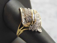 A WOMENS VINTAGE ESTATE 10K YELLOW GOLD DIAMOND CLUSTER RING. THE RING IS A SIZE 10.0 AND WEIGHS 4.1g. THERE ARE ABOUT .44cts OF DIAMONDS. THE RING MAKES A BEAUTIFUL, IMPRESSIVE GIFT FOR THAT SOMEONE SPECIAL. ANY OTHER QUESTIONS, PLEASE ASK. BE SURE TO CHECK OUT SOME OF MY OTHER GREAT ITEMS UP FOR SALE. THANK YOU Collectible Gold Rings With Diamond Accents, Gold Collectible Cluster Ring, Classic Gold Bypass Ring With Diamond Cut, Vintage Gold Bypass Ring For Anniversary, Classic Gold Cluster Rings, Antique Gold Cluster Diamond Ring, Yellow Gold Diamond Ring, Chalcedony Ring, Sapphire Diamond Ring