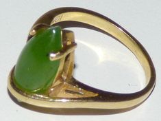 Elegant vintage cocktail ring, crafted in 10 karat yellow gold. Centrally mounted marquise cabochon natural jadeite jade measuring 6.50mm x 16mm x 2.52mm (estimated at 3 carats). The jade is in excellent condition and free of cracks or chips. Weight 4gramm To see my complete collection of fine antiques and quality vintage collectibles, please view the contents of my shop at https://www.etsy.com/shop/Antike?ref=hdr_shop_menu Thank You! Classic Green Marquise Rings, Formal Green Marquise Jewelry, Green Marquise Hallmarked Jewelry, Vintage Cocktail Ring, Jade Ring, Vintage Cocktail, Vintage Collectibles, 3 Carat, Cocktail Ring