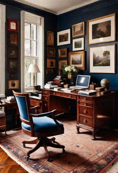 an office with blue walls and pictures on the wall above it, along with a chair in front of a desk