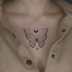 a woman's chest with a butterfly and cross tattoo on the left side of her stomach