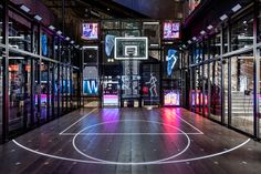 an indoor basketball court is lit up with neon lights