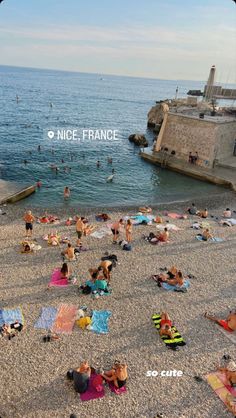 many people are on the beach and in the water