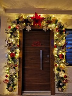 a door decorated with christmas decorations and lights