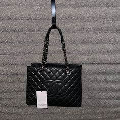 Classic Chanel Grand Shopping Tote (Gst) Rendered In Grey Quilted Caviar Leather, Featuring Interlocking 'Cc' Logo Embroidery On Front And Finished With Silver-Tone Chain-Link Hardware. The Color Is A Very Dark Charcoal Grey. Excellent Condition This Bag Does Not Have Any Scratches, No Rips, No Stains, Smoke Free Home. If You Have Any Questions About Any Of The Pics Let Me Know And I’ll Upload More. Happy Poshing Features: Two Leather And Chain-Link Shoulder Straps Interior Zip Compartment, Inte Chanel Grand Shopping Tote, Classic Chanel, Cc Logo, Shopping Tote, Logo Embroidery, Embroidery Logo, Chanel Bag, Charcoal Grey, Chanel Classic