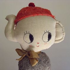 a stuffed animal with a red hat on top of it's head and eyes