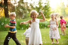 children playing with soap bubbles in the park