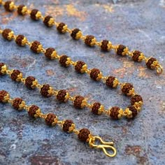 Beads is made using hand-picked, highest quality, smooth, hard, round and lustrous 5 mukhi Rudraksha beads from Java (Indonesia) along with a beautiful orange tassel. The mala can be worn or can be used for Mantra Japa. Benefits and Purpose: 5 mukhi Rudraksha beads enhances self-work and induce confidence 5 mukhi Rudraksha bead blesses the wearer with health, prosperity, and success The Mala increases concentration, memory and creativity The Mala helps aid meditation and Spiritual sadhana Size: Festival Brown Necklace For Puja, Brown Necklaces For Puja And Festivals, Temple Necklace With Tilla And Round Beads For Festivals, Temple Necklace With Latkans And Round Beads For Festivals, Festival Temple Necklace With Tilla And Round Beads, Gold Mala With 8mm Beads For Meditation, Festival Mala With Gemstone Beads For Puja, Festival Mala With Polished Beads, Gemstone Beads Mala For Puja And Festivals