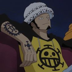 a cartoon character with tattoos on his arm and hand in front of him, wearing a yellow t - shirt