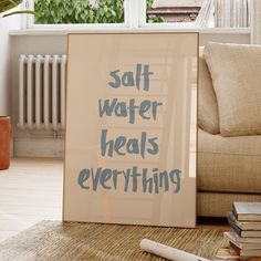 a sign that says salt water heals everything on the floor in front of a couch