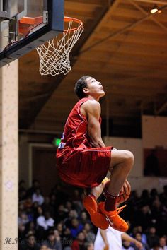 a basketball player jumping up into the air to dunk