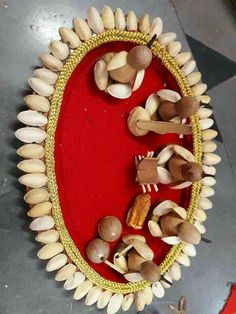 an arrangement of mushrooms and other items on a red tablecloth with gold trimmings