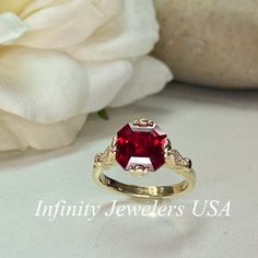 "The ring pictured is lab created ruby #6214 Shown in 14k yellow gold and 14k white gold **Ruby is birthstone of July** -Approximate total carat weight: 3.26ctw. diamond equivalent approx. -Center Stone Size: 9x9mm - approx. 3.20ct. diamond equivalent approx. -Gem Type: Lab created red ruby -Center Stone Shape: asscher cut -Center Stone Color: red -Center Stone Clarity: AAA -Moh's Scale: 9 Hardness -Accent Stones: natural diamonds -Accent Stone Weight: 0.06ctw. Approx. -Accent Stone Color: G -Ac Yellow Gold Jewelry With Lab-created Ruby For Anniversary, Asscher Cut Ruby Ring With Prong Setting For Anniversary, Ruby Jewelry With Asscher Cut For Anniversary, Red Ruby Birthstone Ring Stamped 14k, Emerald Cut Red Birthstone Ring In 14k Gold, Yellow Gold Birthstone Ring With Prong-set Lab-created Ruby, Asscher Cut Ruby Ring For Anniversary, Yellow Gold Lab-created Ruby Birthstone Ring For Anniversary, Asscher Cut Ruby Ring With Center Stone