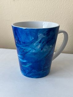 a blue cup sitting on top of a white table