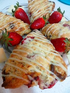 strawberry scones with cheese drizzled on them and sliced strawberries in the middle