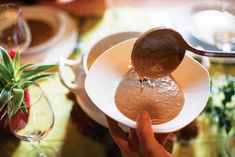 a person is pouring water into a bowl