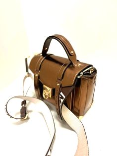 MICHAEL KORS MANHATTAN MEDIUM WOMEN SCHOOL SATCHEL CROSSBODY HANDBAG PURSE MOCHA ABOUT THE ITEM Please look at approximate dimension below before purchasing.  APPROX. DIMENSIONS: Length (L): 9" Height (H): 7" Depth (D): 4.25" 100% Authentic or Money Back Guarantee~~~ALWAYS!!! EXTERIOR FEATURES  Coated Canvas Material Gold Tone Hardware  Metal Corners Michael Kors Embossed Flap Lock Closure Large Pocket Under Front Flap Leather Top Handle Adjustable Leather Strap for Shoulder or Cross Body Wear INTERIOR FEATURES Large Roomy Interior Fully Lined Interior One Back Slip Pocket One Front Slip Pocket Luxury Brown Saddle Bag With Branded Hardware, Designer Brown Flap Bag, Brown Designer Flap Bag, Formal Brown Saddle Bag With Branded Hardware, Brown Rectangular Flap Bag With Branded Hardware, Designer Brown Shoulder Flap Bag, Luxury Brown Satchel With Flap, Luxury Brown Flap Satchel, Formal Brown Satchel With Branded Hardware