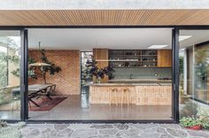 an open kitchen and dining room with sliding glass doors