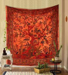 an orange tapestry hanging on the wall in a living room