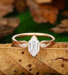 a close up of a ring on top of a leaf