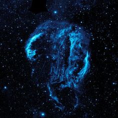 an image of the sky with stars and blue light in it, as seen from space