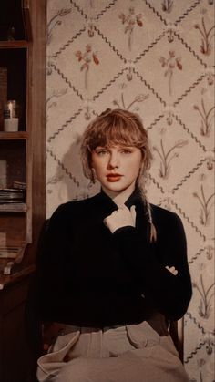 a woman sitting in a chair with her arms crossed