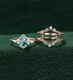 two rings with green and white stones on them, one is made out of gold