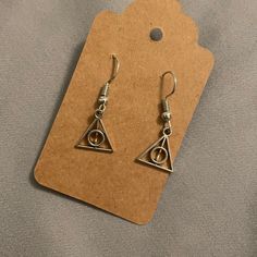 the earrings are made out of silver wire and have an eye shaped design on them