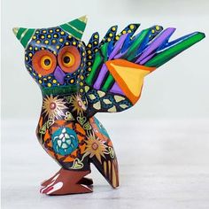 a colorful owl figurine sitting on top of a table