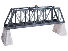 a model train bridge with two cars on it