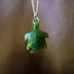 Large turtle jade necklace. Gorgeous translucent green. The pendant is made from nephrite jade mined from British Columbia, Canada. Order is one jade turtle. The pendant comes with a silver plated steel jump ring. Option to buy sterling silver chain necklaces. Jade brings harmony and contentment to the wearer. In Asian cultures, Jade is revered as the good luck stone which can bring happiness, wealth, and friendship. 5.3 grams 31mmx24mmx5.5mm Green Jade Spiritual Necklace, Spiritual Green Jade Necklace, Handmade Dark Green Jade Jewelry, Green Carved Healing Necklace, Green Carved Necklaces For Healing, Healing Green Carved Necklaces, Healing Green Carved Necklace, Green Turtle, Carved Jade