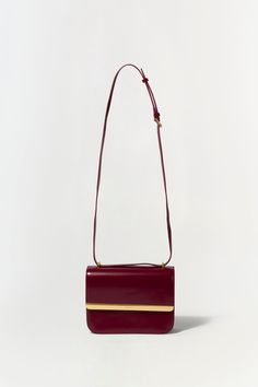 FALL 2024 WOMEN'S COLLECTION The Remy Bag in Oxblood. Featuring a sleek design and gold accent, add sophistication to your outfit with this elegant flap bag. Perfect for day-to-night transitions, it effortlessly combines style and functionality. SIMKHAI Women's Remy Bag in Oxblood Elegant Gold Flap Bag, Burgundy Crossbody Flap Bag For Formal Occasions, Formal Burgundy Crossbody Flap Bag, Timeless Gold Flap Bag For Formal Occasions, Modern Burgundy Bags For Formal Occasions, Classic Gold Flap Bag For Office, Classic Gold Flap Bag For Formal Occasions, Chic Gold Flap Bag For Everyday Luxury, Gold Rectangular Flap Bag For Everyday Luxury