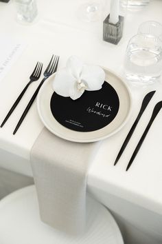 a white table with black and white place settings