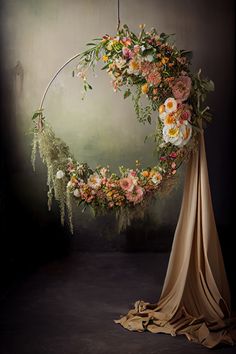 an artistic photo with flowers and greenery in the middle, hanging on a circular frame