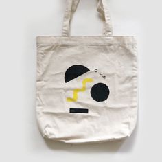 Block Printed and Hand Drawn on Totes. One of a kind. Each graphic will look slightly different. Tote Bag from BAGGU. A simple and easy canvas tote bag crafted from 8 oz cotton (that's 65 % recycled material). 11.8 in. W x 15 in. H x 3 in. D. 11.5 in. strap drop. 100% 8 oz. cotton (65% recycled). Spot clean. Hand Wash Only. Painted Blocks, Handpainted Tote, Handpainted Tote Bags, Easy Canvas, Craft Tote Bag, Weekender Tote, Canvas Tote Bag, Recycled Materials, Canvas Tote