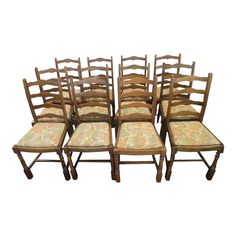 set of eight chairs with upholstered back and seat cushions in the style of an old