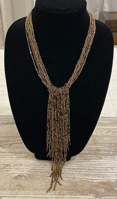 Beaded Bronze Brown Gold Tone Vintage Statement Necklace  In excellent condition  Total length unclasped and lying flat is 22" Adjustable Beaded Tassel Necklace For Party, Elegant Adjustable Beaded Necklaces With Fringe, Adjustable Gold Beaded Fringe Necklace, Gold Beaded Dangle Tassel Necklace, Adjustable Gold Necklaces With Beaded Fringe, Gold Beaded Tassel Long Necklace, Adjustable Gold Beaded Tassel Necklace, Gold Beaded Tassel Necklace, Brown Gold