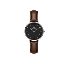 Keep timekeeping simple with the Daniel Wellington Petite Watch. This versatile piece features a comfortable leather strap, which secures the 28mm silver-tone stainless steel case around your wrist. Contrasting hands and hour markers pop against the black dial. Your time is always just a glance away. Classic Everyday Watch With Round Dial, Classic Watch With Round Dial For Work, Classic Everyday Watch Accessories With Metal Dial, Classic Analog Watch Accessories For Everyday, Classic Watch For Workwear, Classic Watch For Work, Classic Everyday Leather Watch, Classic Leather Watch Accessories For Work, Classic Watches With Leather Strap For Work