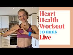 a woman standing in a kitchen making a heart shape with her hands and showing the words heart health workout 30 mins live