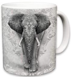 an elephant is shown on a white coffee mug with ornate designs and scrolls around it