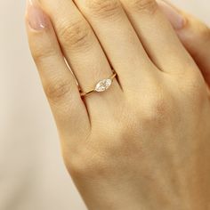 This stunning 14k gold ring features a beautiful marquise cut moissanite, measuring 8x4mm. DETAILS ABOUT THE RING, MATERIAL AND STONES Ring Band: 14K YELLOW GOLD Ring Band size: 1.2 mm thick Gemstone: Moissanite Moissanite size: 8x4mm marquise cut. (0.50 ct. ) D color *** All our raw materials are sourced from US-based companies for the quality and safety of our handmade products. *** this ring is handcrafted for you in our local studio in Redlands, California. We are a small workshop which spec Dainty 14k Gold Marquise Cut Diamond Ring, Dainty Marquise Cut Ring With Single Diamond, Dainty Marquise Diamond Ring In 14k Gold, Promise Ring With Single Diamond In Marquise Shape, Minimalist Marquise Diamond Promise Ring, Minimalist 14k Gold Marquise Ring, Marquise Single Diamond Promise Ring, Dainty Marquise Diamond Ring With Brilliant Cut, Dainty Solitaire Marquise Cut Ring