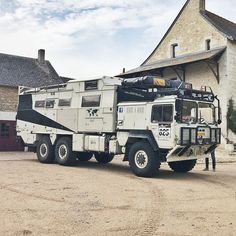 an army truck parked in front of a building