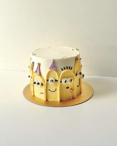 a yellow cake with three faces on it