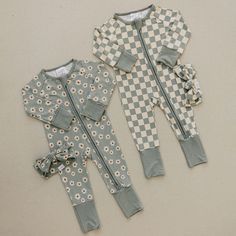 Made from the softest bamboo blend, these zippered pajamas are the perfect outfit to snuggle your little one in this spring! Featuring a sweet daisy print on a trendy sage green background, these pajamas feature foot cuffs, allowing your babe to wear them as footies or a romper. Finished off with a double zipper that zips from the top and bottom for easy changes, these jammies truly are a baby essential! Features Light green fabric with daisy pattern throughout 95% Bamboo, 5% Spandex Double zipp Easter Pajamas, Baby Luna, Toddler Essentials, Baby Bamboo, Green Daisy, Diaper Bag Accessories, French Baby, Green Checkered, Nursing Wear