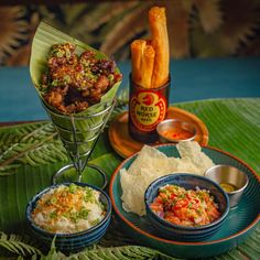 some food is sitting on a table with other foods and condiments around it