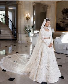 a woman in a white wedding gown and veil